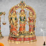 Brass Ram Darbar idol with three figures, red and blue painted outfits, arched frame