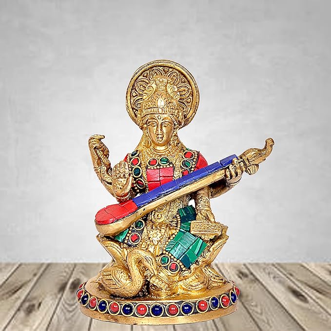 Maa Saraswati statue holding veena and book, gold with red/green jeweled trim
