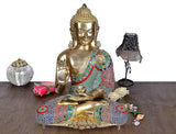 Brass Buddha idol in Abhaya mudra, seated with jeweled multicolor robe and 16 in height