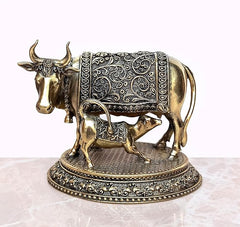Gold-toned brass cow and calf figurine on textured base with engraved panel