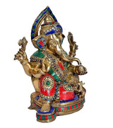 Brass Ganesha idol statue angled view, multicolour patterned dhoti, raised arms