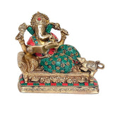 Seated Ganpati Ganesha brass statue holding a book, teal outfit with gold and red details