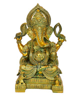 Brass Ganesha idol with multi-color detailing, seated pose, ornate jewelry and crown