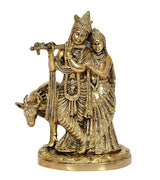 Brass Radha Krishna statue idol showing detailed faces, crowns, and draped jewelry