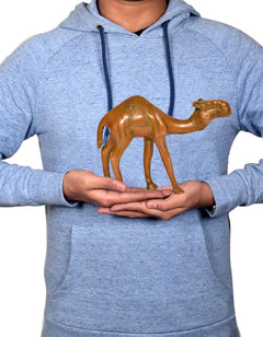 AONA brass camel figurine, 6-inch, held in hands, engraved pattern with green details