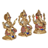 Brass Saraswati, Lakshmi & Ganesha murtis, seated figures with red, blue, white accents