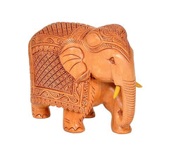 Elephant wooden statue, front three-quarter view; carved blanket pattern and trunk down.