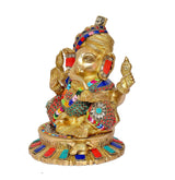 Ganesh idol seated on lotus base, gold tone, pagdi turban and jeweled red-blue trims