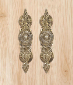 Golden brass door handle pair, two matching pointed shields with central rosette
