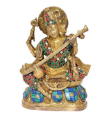 Saraswati statue with veena, ornate gold look and multicolour patterned attire and gems
