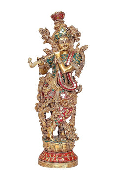 Brass Krishna decorative idol, front view holding flute, ornate crown and teal-red jeweled work