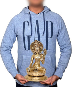 Brass Indra dev statue held in hands, seated on lotus with halo and trident