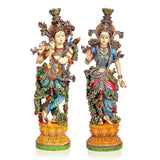 Resin Radha-Krishna figurines, front view with ornate crowns, jewelry, and jeweled bases