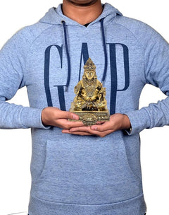 Person holding 5-inch Kuber idol statue in bronze-gold finish