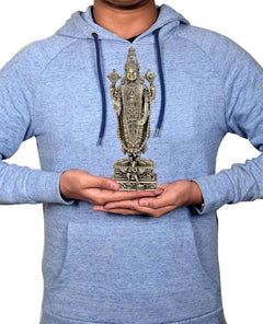 Hands holding 8 inch brass Lord Tirupati Balaji figurine for size reference