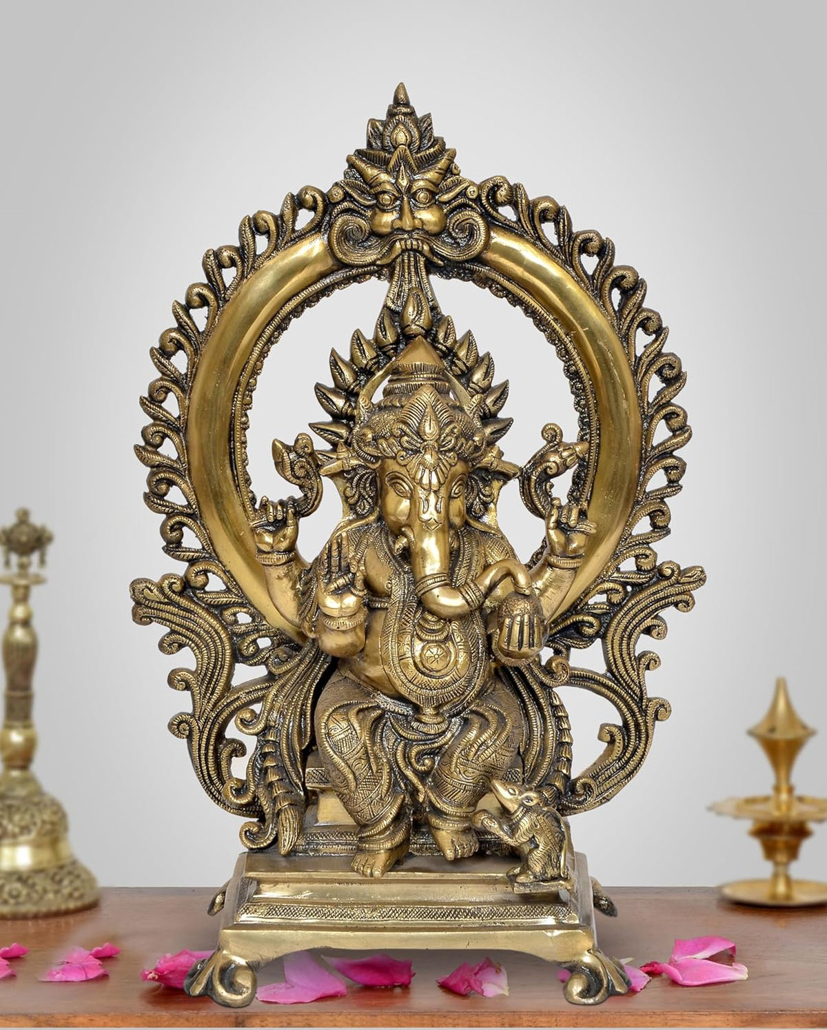 Natural brass Ganesha idol on throne with ornate halo, front view