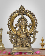 Natural brass Ganesha idol on throne with ornate halo, front view