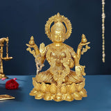Golden brass Lakshmi deity statue seated with four arms and ornate crown