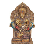 Kuvera deity statue idol, front view, antique bronze with blue-green ornaments and red sash