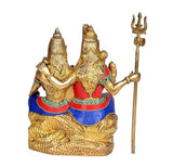Brass Shiv-Parvati idol from side, blue-red robes, long trident staff