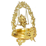 Brass Ganesha swing urli close side view of carved base, hanging chains, and deity