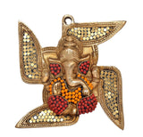 Ganesha swastik wall decor, gold dots with red accents and orange garland beads
