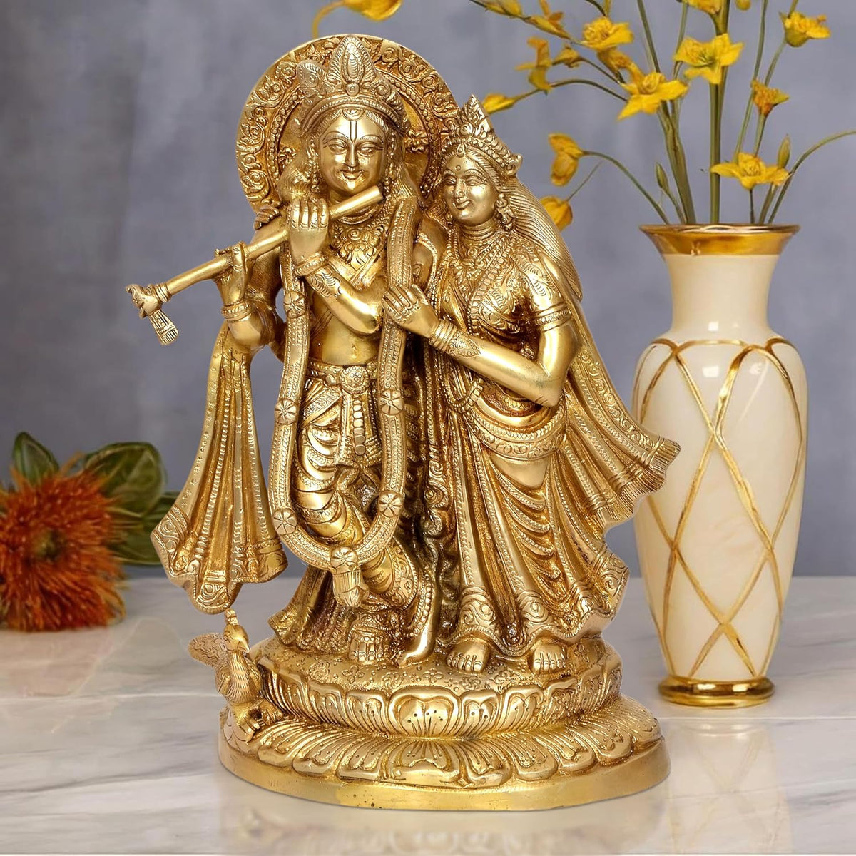 Brass Radha Krishna idol statue in ornate pose, standing on detailed round base