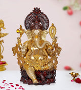 Gold and dark red Ganesha brass idol statue with four arms, seated on ornate base