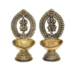 Brass Lakshmi and Ganesha diya oil lamps, front view of two standing holders