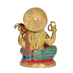 Brass Saraswati idol from back/side view; long hair, halo, and colorful jeweled details