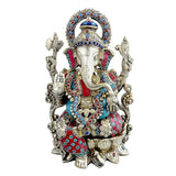 Brass Ganesha statue with carved dhoti, jeweled halo and four arms, 12.9 in