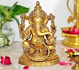 Brass Ganesha statue idol on base, gold-tone finish, intricate crown and jewelry