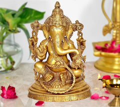 Brass Ganesha statue idol on base, gold-tone finish, intricate crown and jewelry