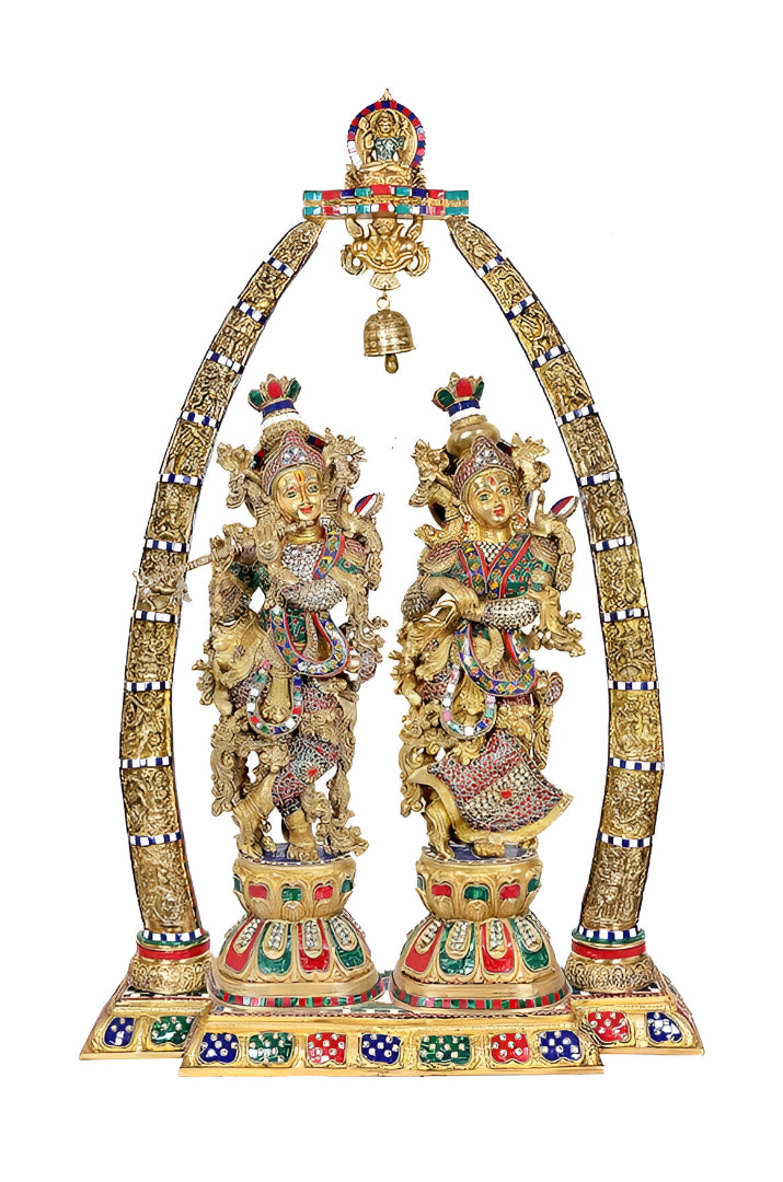 Brass Radha-Krishna statue with ornate arch, colorful details, hanging bell