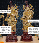 Brass Radha Krishna idol, front view with gold ornaments and maroon decorative base