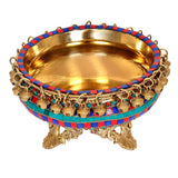 Brass urli bowl with gold interior, teal-and-red beaded edge and side chains