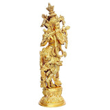 Brass Krishna statue in dynamic stance, intricate engravings on body and base