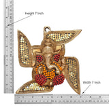 Ganesha swastik wall hanging, shown with 7 in height on measuring ruler, gold