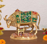 Brass Kamdhenu cow statue with calf, green enamel floral patterns and gold detailing