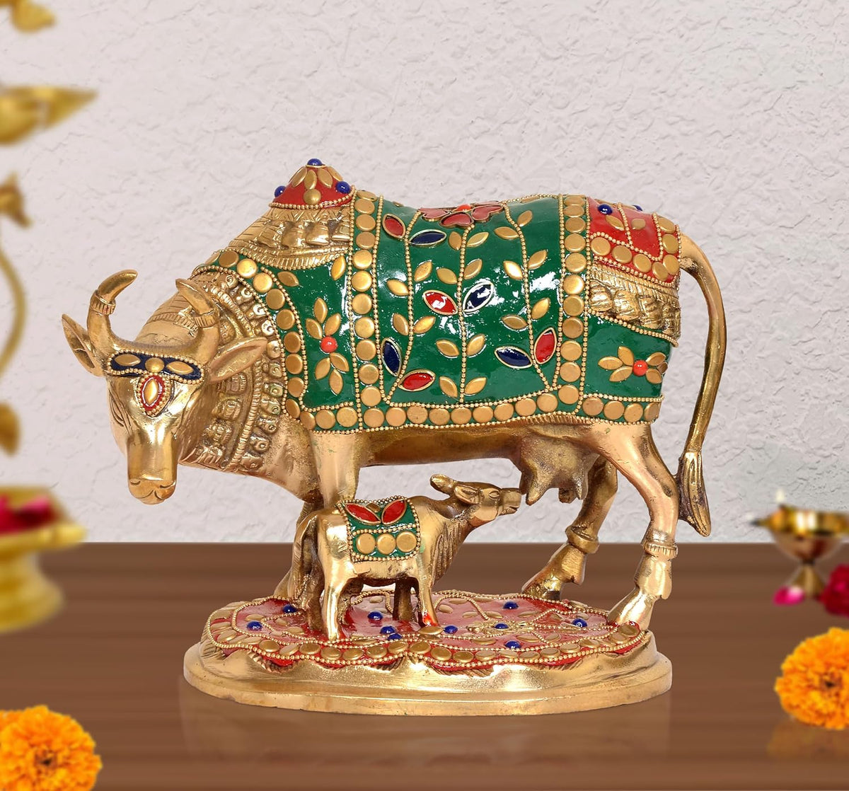 Brass Kamdhenu cow statue with calf, green enamel floral patterns and gold detailing