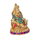 Lord Kuber brass idol, side view: seated deity with jeweled teal and red attire