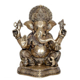 Brass Ganesha statue idol, front view with detailed trunk, four arms and jeweled ornaments