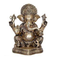 Brass Ganesha statue idol, front view with detailed trunk, four arms and jeweled ornaments