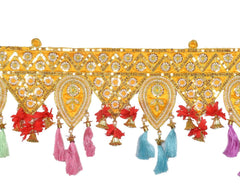 Close-up toran with gold embroidery, oval medallions, red flowers, and multicolor tassels