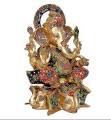 Ganpati brass murti from angled view, painted patterns on garments and lotus seat