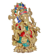 Brass Ganesha statue, angled view, colorful headpiece and intricate gold filigree