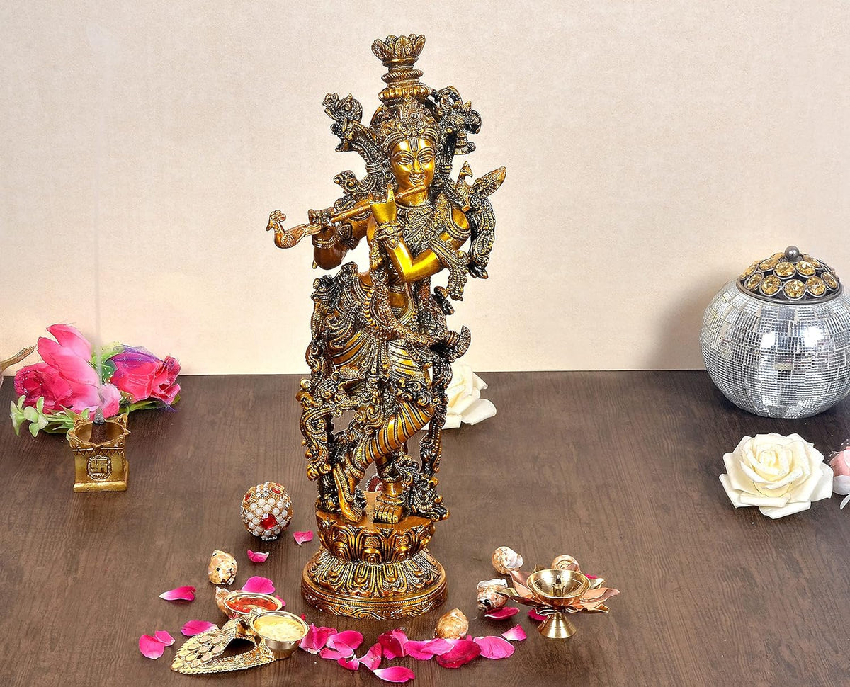 Brass Lord Krishna idol with ornate crown, flute, and standing pose on pedestal