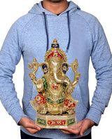 Brass Ganesha statue held in hands on height display, multicolor jewel details on pedestal