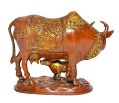 Brass cow with calf statue, side view with detailed ornaments and relief work