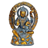 Seated Shiva idol with dark blue body, gold-toned face, halo arch, and trident-like details